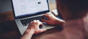 person typing on a laptop
